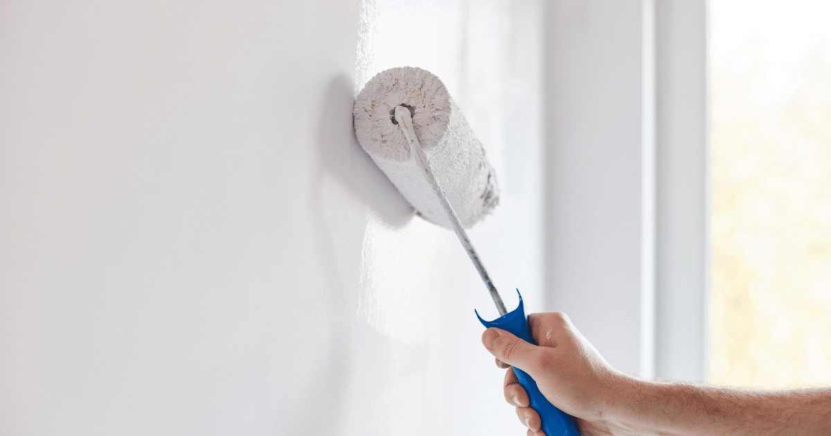 A person painting the wall to increase the rental rate